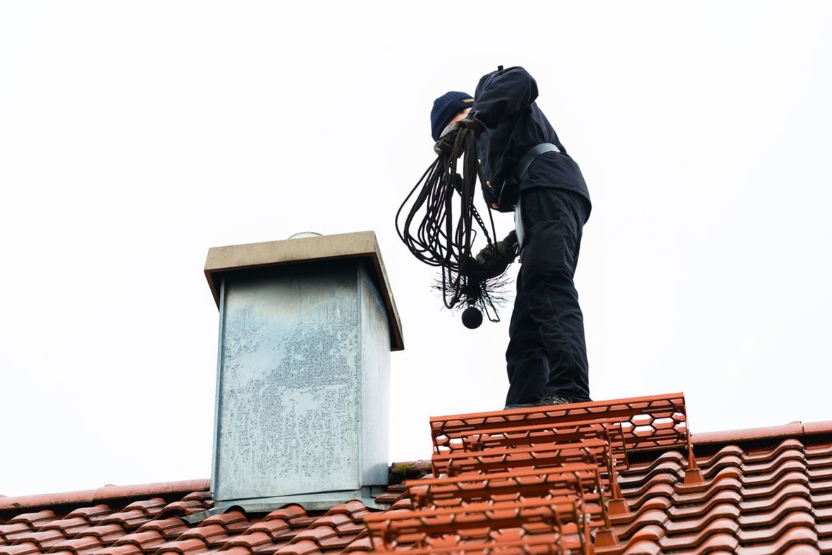 a chimney sweep on top of a roof